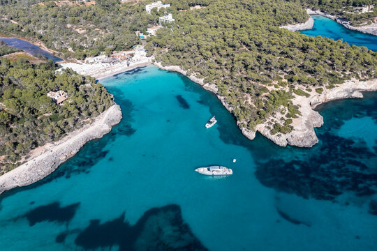 Boats in sea at Calo des Borgit, Mondrago Nature Park, Majorca, Spain