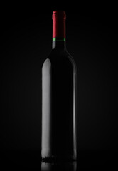 full bottle of red wine on a black background