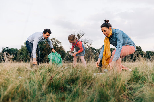 Family doing cleanup in public park