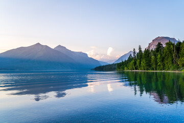Sunset over Lake McDonald in Glacier National Park in Montana - colorful pebbles visible through...