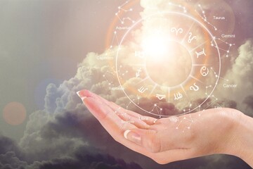 Zodiac signs inside of horoscope circle astrology and horoscopes concept in hands