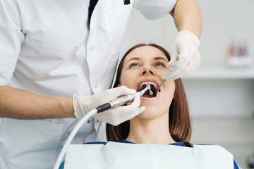 Overview of dental caries prevention, Girl at the dentist chair during a dental scaling procedure, Healthy Smile. - obrazy, fototapety, plakaty