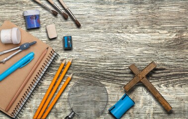 Office or school supplies with Christian cross on the desk