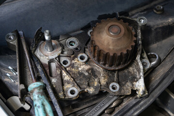 A rusty, jammed water pump with a tool nearby. Car service at a car service