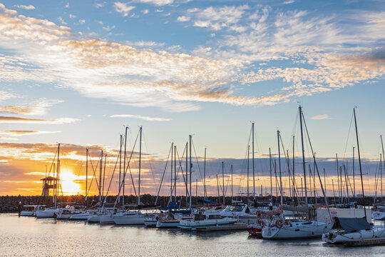 Australia, Victoria, Melbourne, Boats moored inRoyal Melbourne Yacht Squadron marina at sunset