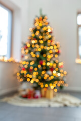 winter holidays, new year and celebration concept - blurred christmas tree lights at home