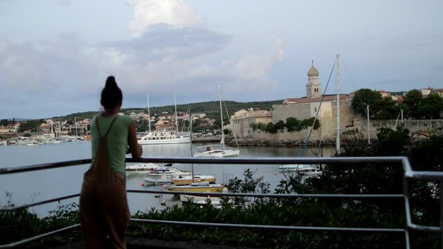 Lady is observing morning Krk City.