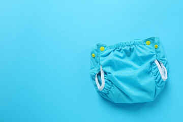 Reusable diapers on blue background, close up