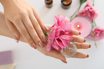 Concept of hand care with cosmetics on white background