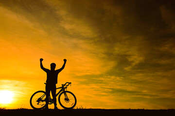 Fototapeta premium Silhouette of handsome man riding bicycle on sunset,sport man concept,Fill flare effect
