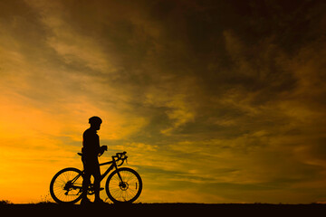 Silhouette of handsome man riding bicycle on sunset,sport man concept,Fill flare effect