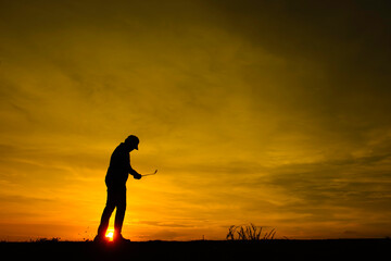silhouette asian golfer playing golf during beautiful sunset