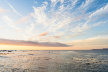 Sunset over calm sea in Algarrobo, Chile. Dramatic blue sky with clouds at twilight