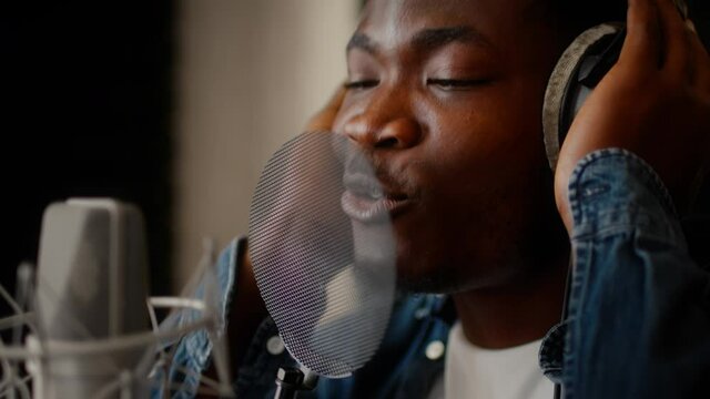 Closeup Shot Of Talented Black Male Singer Recording Song At Music Studio