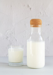 Jar or bottle of organic yogurt or kefir with glass