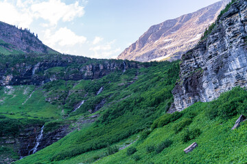 Waterfall on the Going to the Sun Road in Glacier National Park in Montana on a sunny summer evening at golden hour