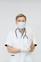Doctor Puts on Gloves and Wearing Medical Mask. Medical Concept on white background