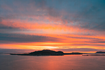 Fototapeta premium Alesund, Norway. Amazing Natural Bright Dramatic Sky In Warm Colours Above Alesund Valderoya And Islands In Sunset Time. Colorful Sky Background. Beauty In Norwegian Nature