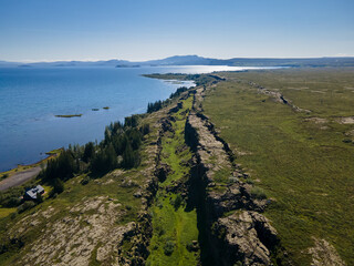 View of Thingvellir national park, Iceland's parliament, the Thingvellir Church and the ruins of old stone shelters, hikes and lake