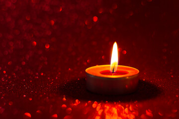 Candles red glitter background. Blurry red background with a little bokeh. Beautiful festive sensual composition. The concept of Valentine's day, wedding, birthday. Merry Christmas and Happy New Year