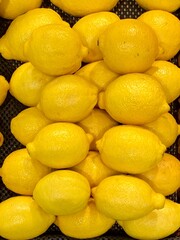 Close-up photo of lemons in market. Fruits background. Texture yellow lemon. 