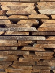Stacked wooden boards. Side shot of wooden planks.