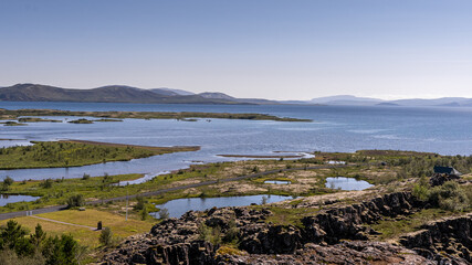 View of Thingvellir national park, Iceland's parliament, the Thingvellir Church and the ruins of old stone shelters, hikes and lake