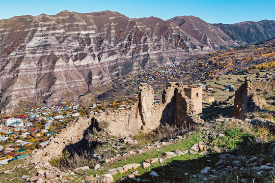 Goorskaya Bashnya near mountain range on sunny day, Dagestan, Russia
