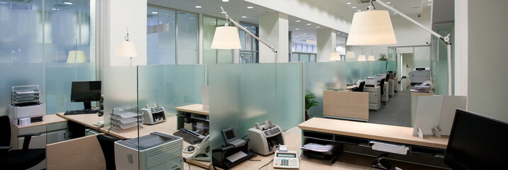 Interior of an empty bank office with working desks in raw