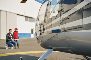 Beautiful mother and her child admiring a cool plane