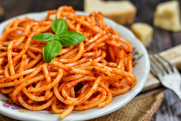 Spaghetti  bolognese .Italian home made meal Fresh  bucatini pasta with tomato sauce, basil, herbs ,parmesan cheese ,fresh cherry tomatoes and parsley on wooden background. Kitchen Poster 