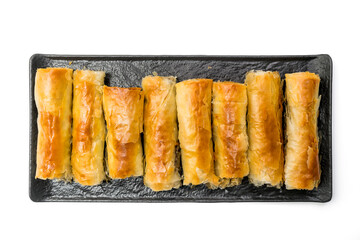 Meat rolls pastry - fried minced pork meat in spring rolls in a black serving plate, isolated on white background with clipping path included. Top View