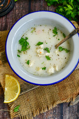 Home made chicken soup with noodles ,parsley and vegetables in white bowl . Healty soup