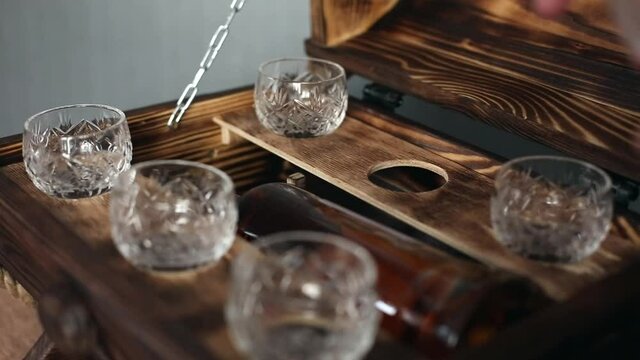 Wine glasses for strong alcohol. Shops and a bottle of alcohol in the minibar. Home bar