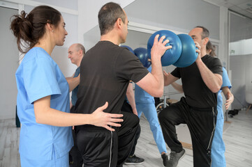 Group of People with disability exercising at rehabilitation clinic. High quality photo