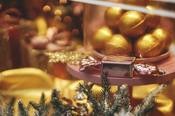 Stylish modern christmas  candy gift and glitter baubles in window, fairytale decoration. Atmospheric magic time. Christmas festive decor for winter holidays. Merry Christmas!