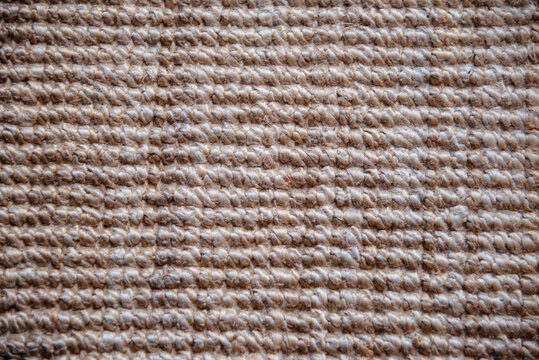 Makro eines beigen Sisal Teppichs, grob gemustert