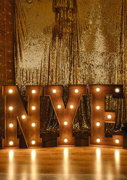 Loft idea for Christmas. Bulb lights on wooden stand letters NYE.
