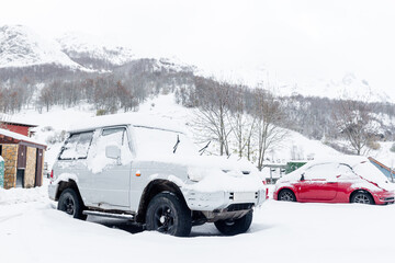 White 4x4 off-road car with all terrain wheels covered in snow. winter concept