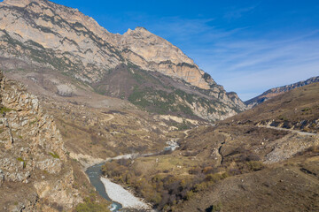 Aerial panoramic view of rapid stream river in deep mountain gorge, Digor Gorge, Northern Ossetia, Caucasus, Russia