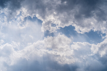 Light sunshine and dark storm clouds gather in the skies over the Missouri River near Helena, Montana on a summer day