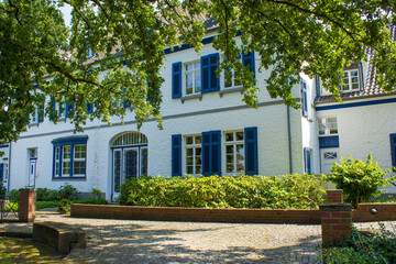 Old German house with windows with wooden shutters, Wachtendonk, Germany