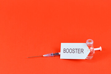 Corina virus booster vaccination concept with vial and syringe in corner of red background with copy space - obrazy, fototapety, plakaty
