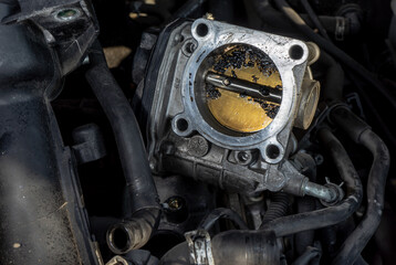 The throttle valve on the engine of a car with contamination due to engine malfunction