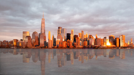 Aerial view of Manhattan during sunset showing reflections on the hudson river