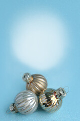 Bright silver Christmas balls on blue background with bokeh and falling snow. Merry Christmas and happy New Year