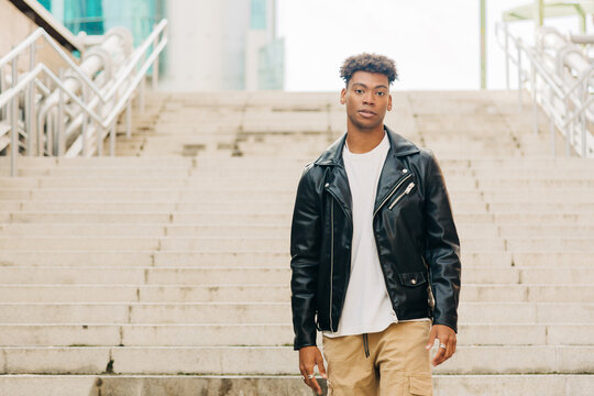 Ethnic male standing on street stairs