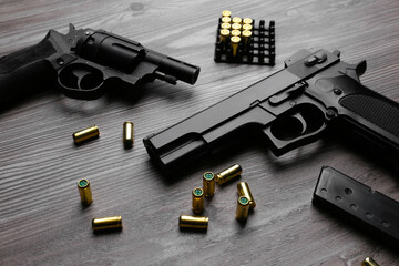 Pistols and bullets on wooden table. Professional guns - obrazy, fototapety, plakaty