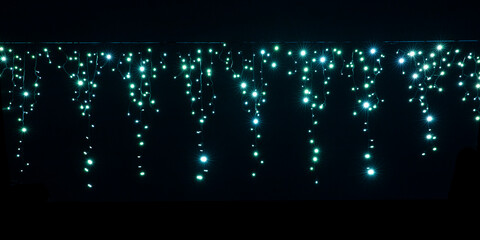 Lichterkette als Weihnachtsbeleuchtung vor dunklem Hintergrund