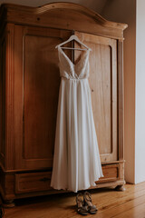 white wedding dress on wooden closet